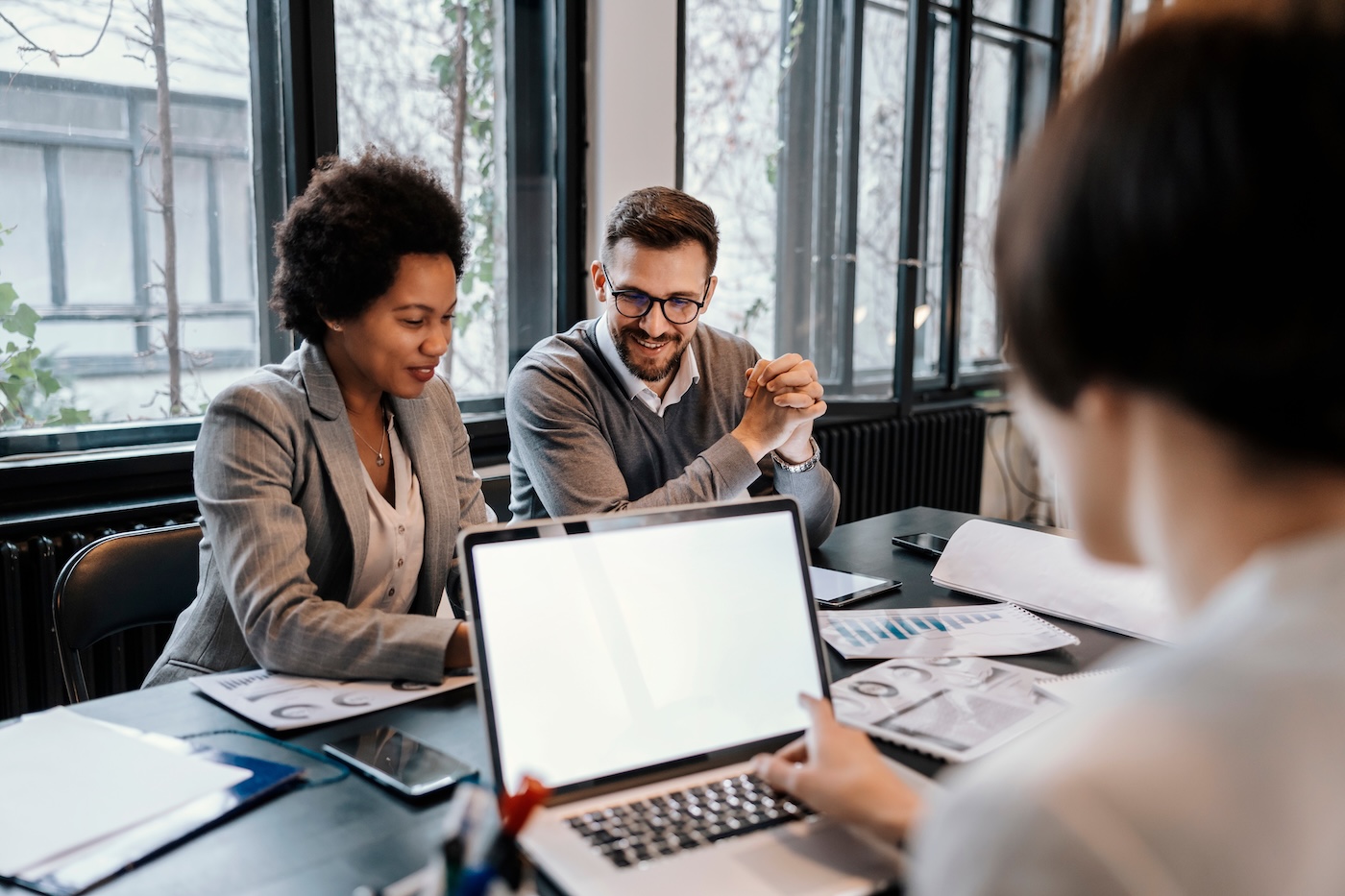 A multiracial executives are sitting at the office and brainstorming about project.